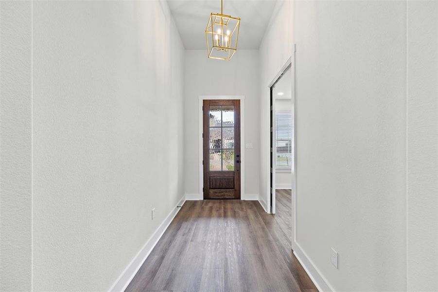 Entryway with wood finished floors and a chandelier Entryway with wood finished floors and a chandelier