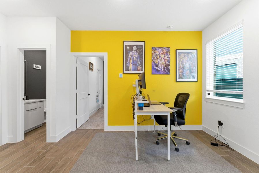 Vibrant accent wall energizes this flexible workspace, perfect for productivity or creative pursuits.