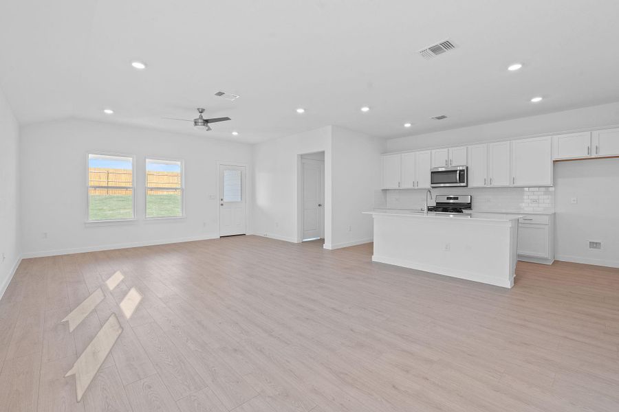 Unfurnished living room featuring light wood-style flooring, recessed lighting, and ceiling fan