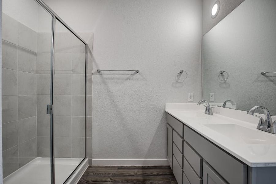 A bathroom with a shower and sink. A bathroom with a shower and sink.
