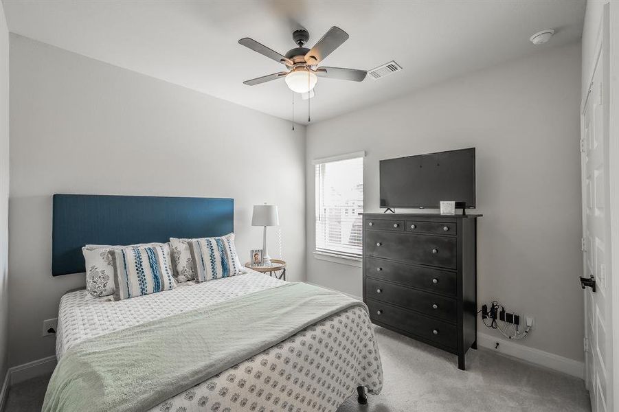 Bedroom featuring carpet and ceiling fan