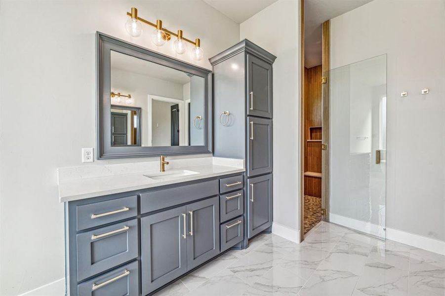 Bathroom with tile patterned flooring, walk in shower, and vanity