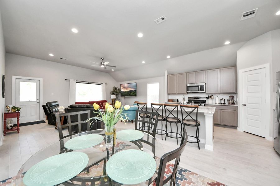 The main living spaces come together in an open layout, illuminated by recessed lighting.