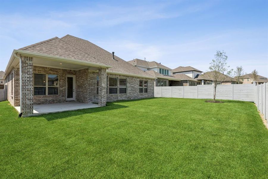 Back of property with a patio area and a lawn