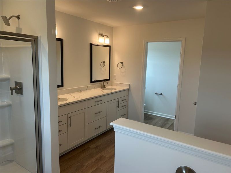 Double vanity with elegant stone counters and a sp