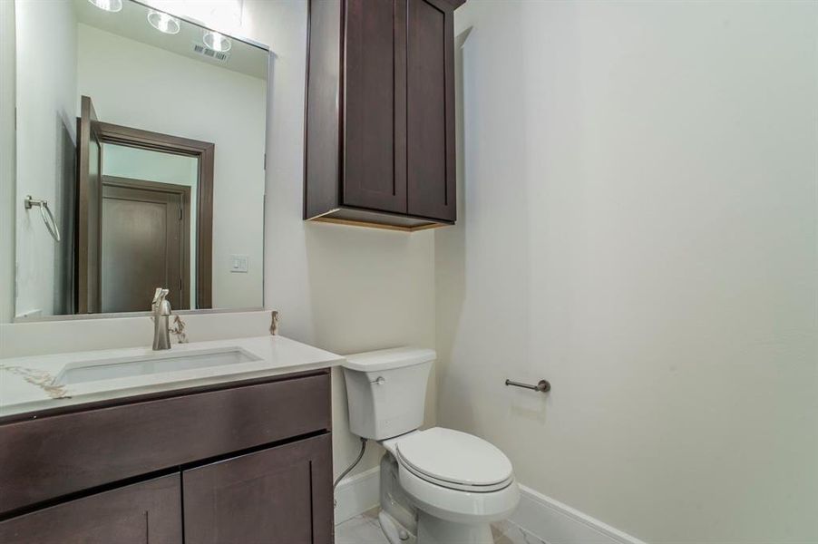 Half bath with vanity and baseboards Half bath with vanity and baseboards