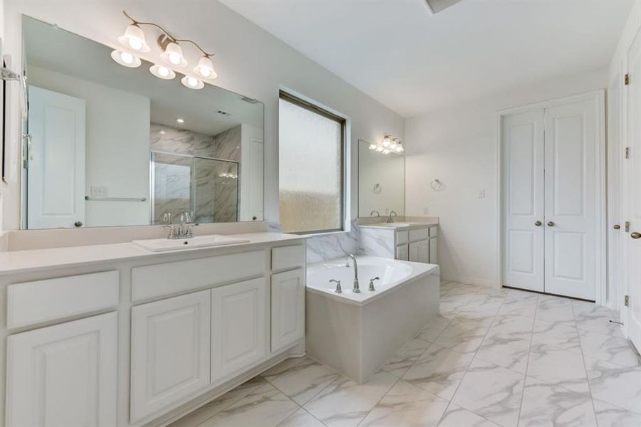 Representative Photo. Dual vanities and Garden Tub in Primary bathroom