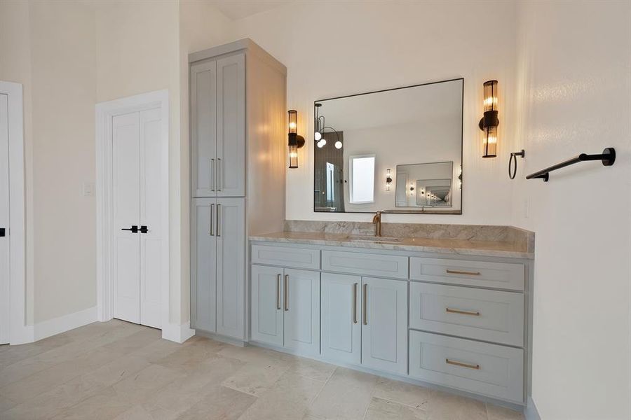 Bathroom featuring vanity and a closet Bathroom featuring vanity and a closet
