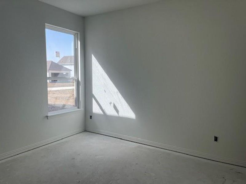 Spare room with unfinished concrete flooring