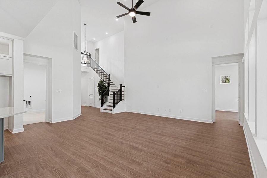 Another view of Living and stairs to 2nd floor with wood treads and iron spindles
