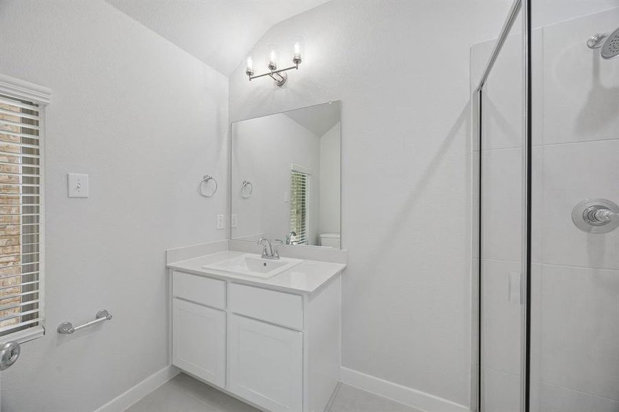 Bathroom in the Masters home plan by Trophy Signature Homes – REPRESENTATIVE PHOTO