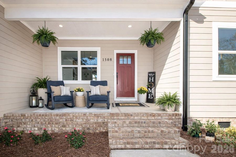 Enjoy this charming covered front porch, ideal for sipping coffee, relaxing, and welcoming guests.