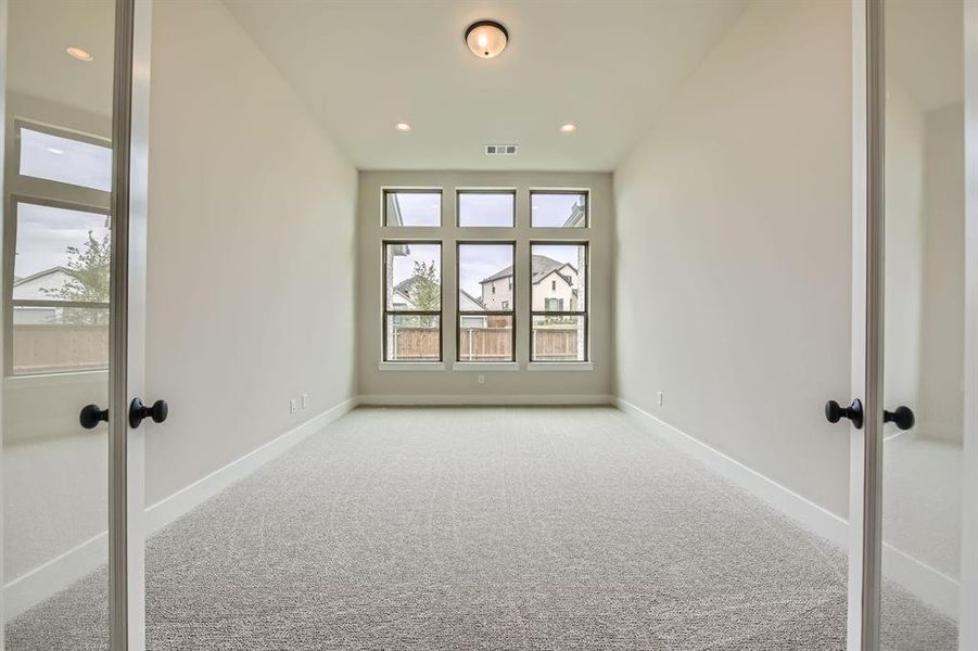 Empty room with carpet, french doors, and recessed lighting Empty room with carpet, french doors, and recessed lighting