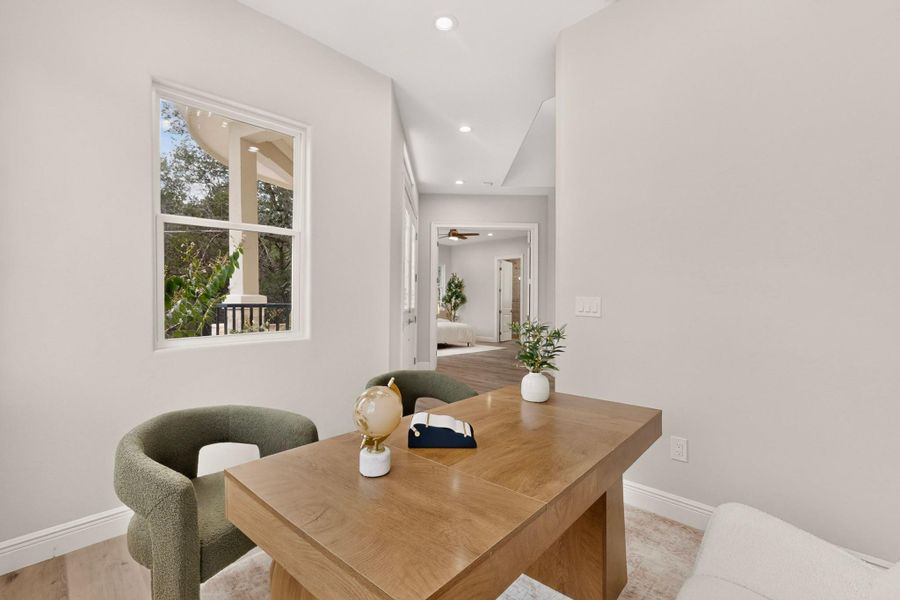 Smooth plaster walls and recessed lighting elevate this versatile home workspace.