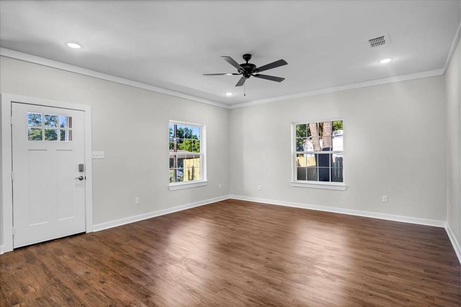 Entryway featuring ornamental molding, dark wood-style flooring, ceiling fan, baseboards, and recessed lighting