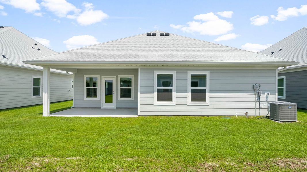 Front exterior of a new home in WindMark Beach, Port Saint Joe, FL, highlighting curb appeal (Image 19).