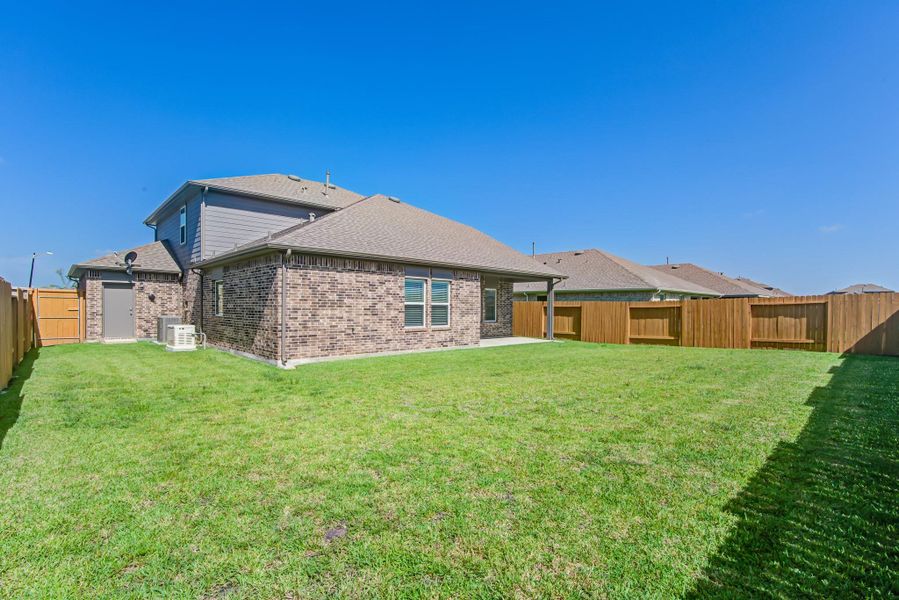 Front exterior of a new home in River Ranch Meadows, Dayton, TX, highlighting curb appeal (Image 25).