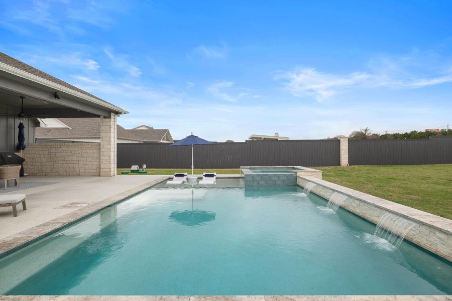 Resort-style pool with tanning ledge and plenty of space to lounge.
