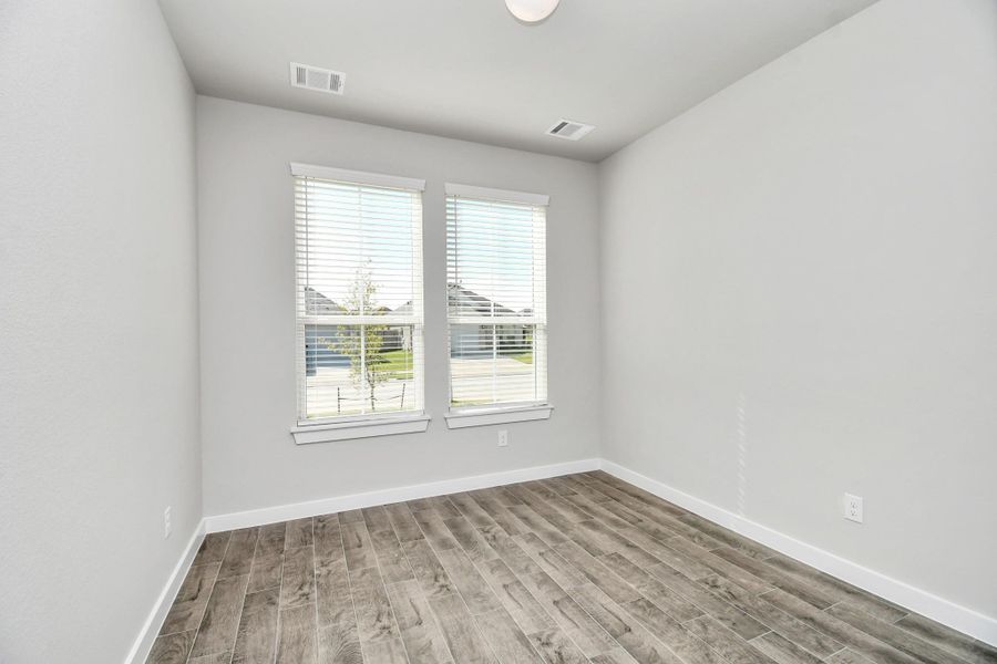 Experience the perfect blend of sophistication and warmth in this home office, boasting elegant wood-look tile flooring and flooded with natural light from expansive windows and French doors. Experience the perfect blend of sophistication and warmth in this home office, boasting elegant wood-look tile flooring and flooded with natural light from expansive windows and French doors.