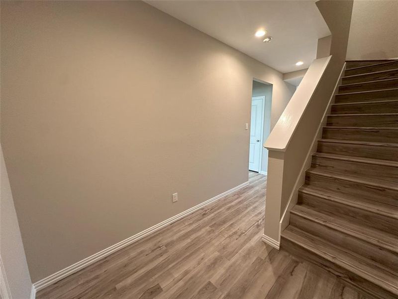 Stairway with hardwood / wood-style floors