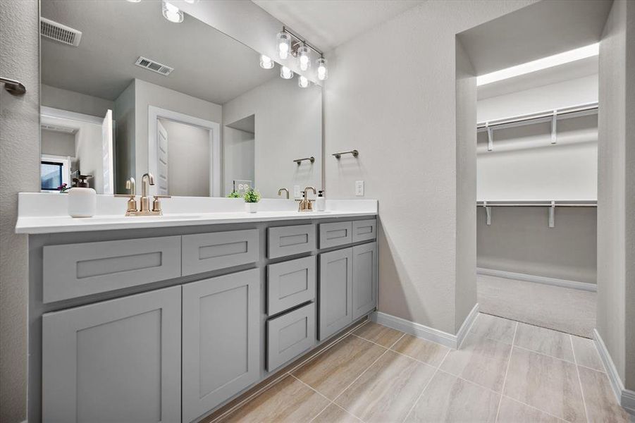 Full bathroom with double vanity and a walk in closet Full bathroom with double vanity and a walk in closet