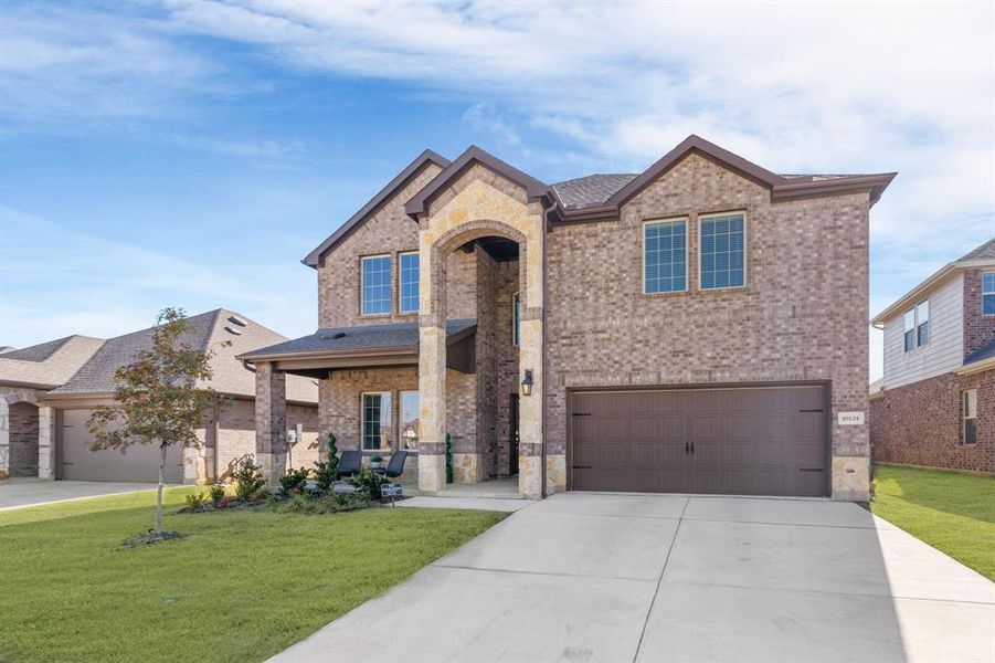 Front exterior of a new home in , Aubrey, TX, highlighting curb appeal (Image 2).