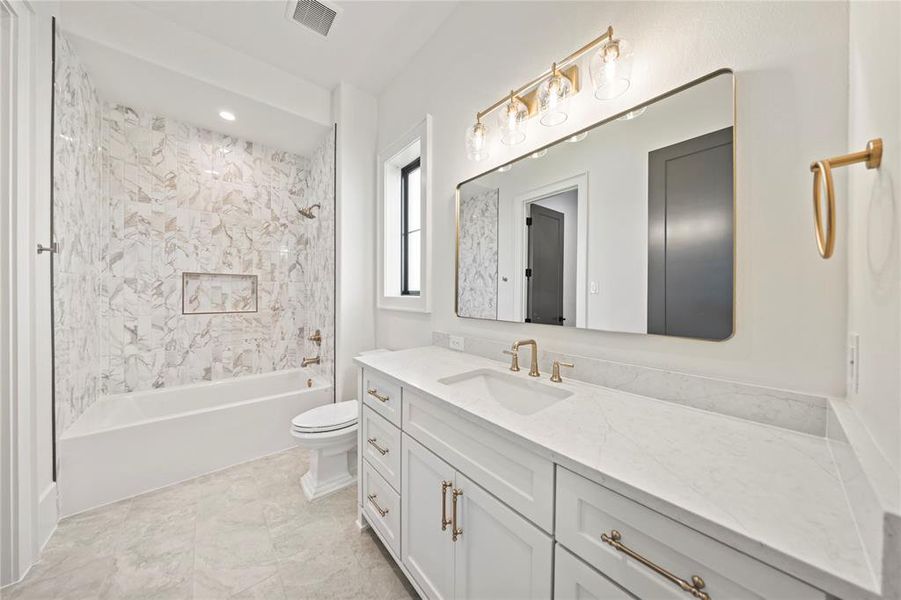 Bathroom featuring vanity, bathtub / shower combination, and recessed lighting