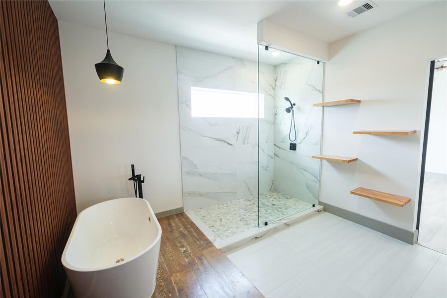 Representative Primary Bath View 3 (Design selections and colors may vary): An alternative view showcases the ample natural light through the clerestory window. The added floating shelves and elegant detailing continues to add openness and practicality to this space.