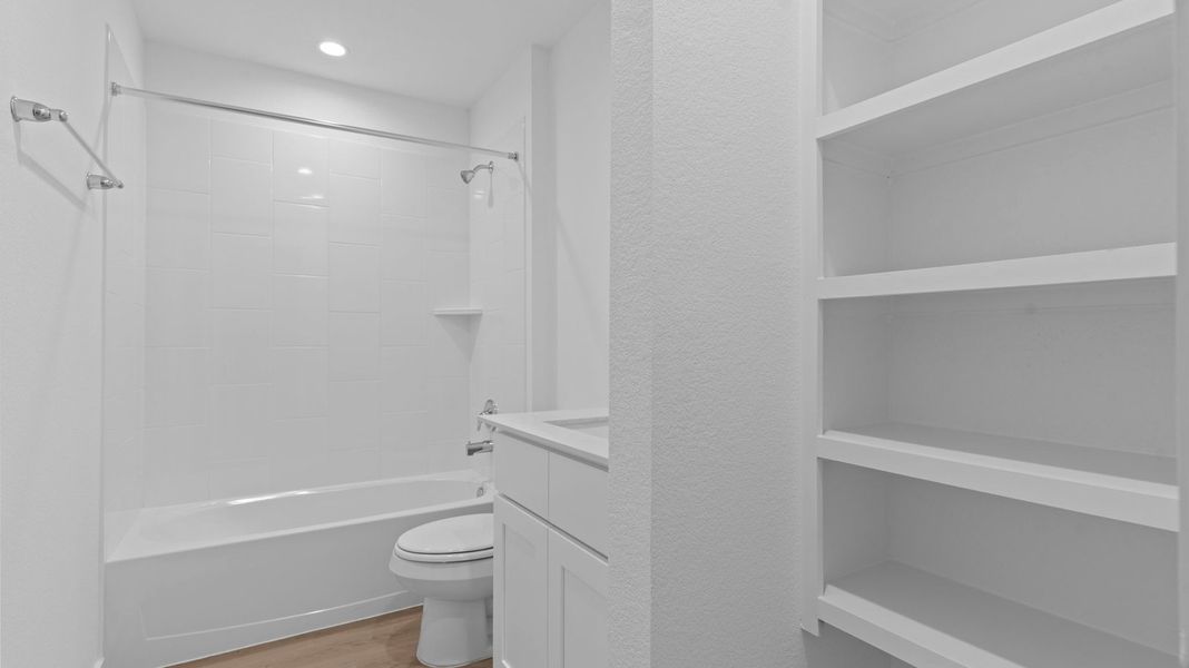 Representative furnished interior of a home built from the Kingston by D.R. Horton in Watermark, Alvin (Image 14).