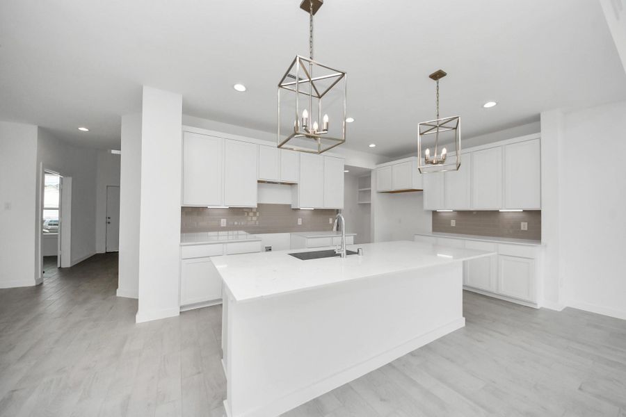 This kitchen is by far any chef’s dream! This spacious kitchen features high ceilings, light stained wood cabinets, granite countertop, SS appliances, modern tile backsplash, recessed lighting, extended counter space, granite kitchen island with double sink, and space for breakfast bar, and a walk-in pantry all overlooking your huge family room. Sample photo of completed home with similar floor plan. Actual colors and selections may vary. This kitchen is by far any chef’s dream! This spacious kitchen features high ceilings, light stained wood cabinets, granite countertop, SS appliances, modern tile backsplash, recessed lighting, extended counter space, granite kitchen island with double sink, and space for breakfast bar, and a walk-in pantry all overlooking your huge family room. Sample photo of completed home with similar floor plan. Actual colors and selections may vary.
