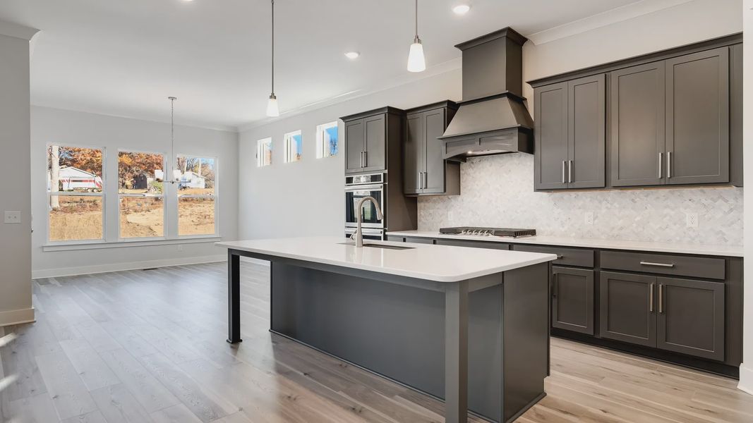 Modern kitchen with nearby dining area with abundance of natural light