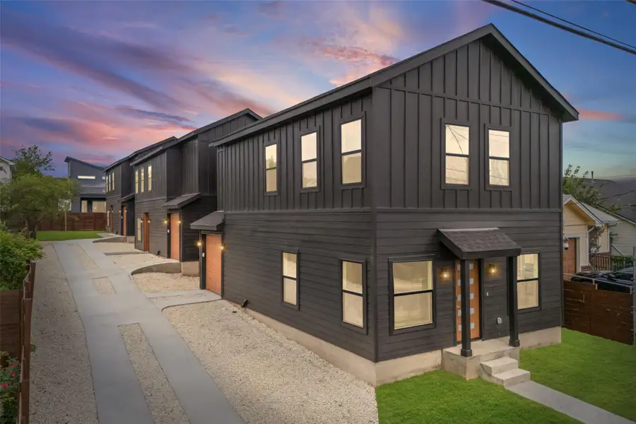 Bold black siding distinguishes this contemporary residence with its inviting front entry and neat landscaping. Bold black siding distinguishes this contemporary residence with its inviting front entry and neat landscaping.