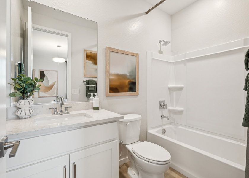 A bathroom with a tub toilet and sink. A bathroom with a tub toilet and sink.