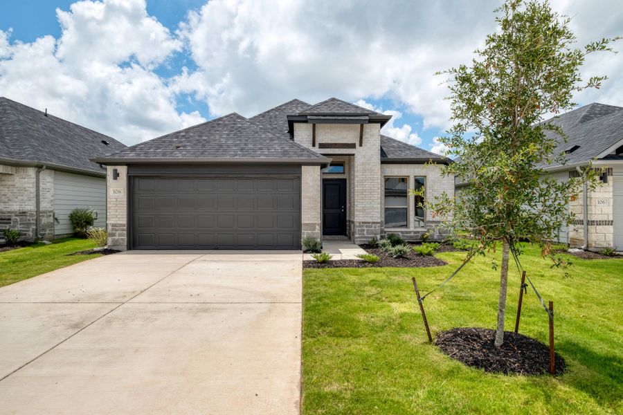Front exterior of a new home in Prairie Winds, Hutto, TX, highlighting curb appeal (Image 1). Front exterior of a new home in Prairie Winds, Hutto, TX, highlighting curb appeal (Image 1).