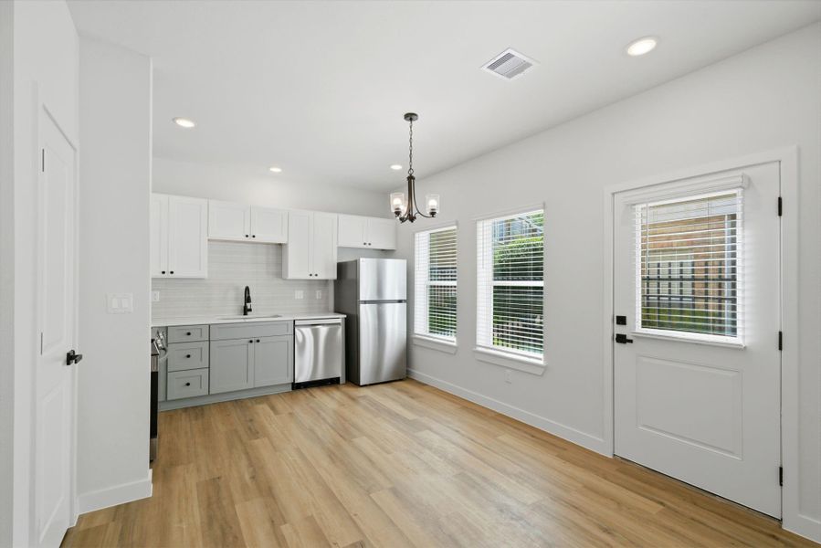 Access to back green space off the kitchen for grilling.