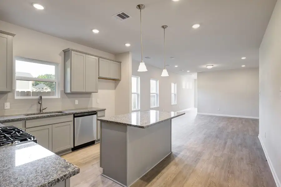 The Mockingbird II- Kitchen into Family Room and Dining Area The Mockingbird II- Kitchen into Family Room and Dining Area