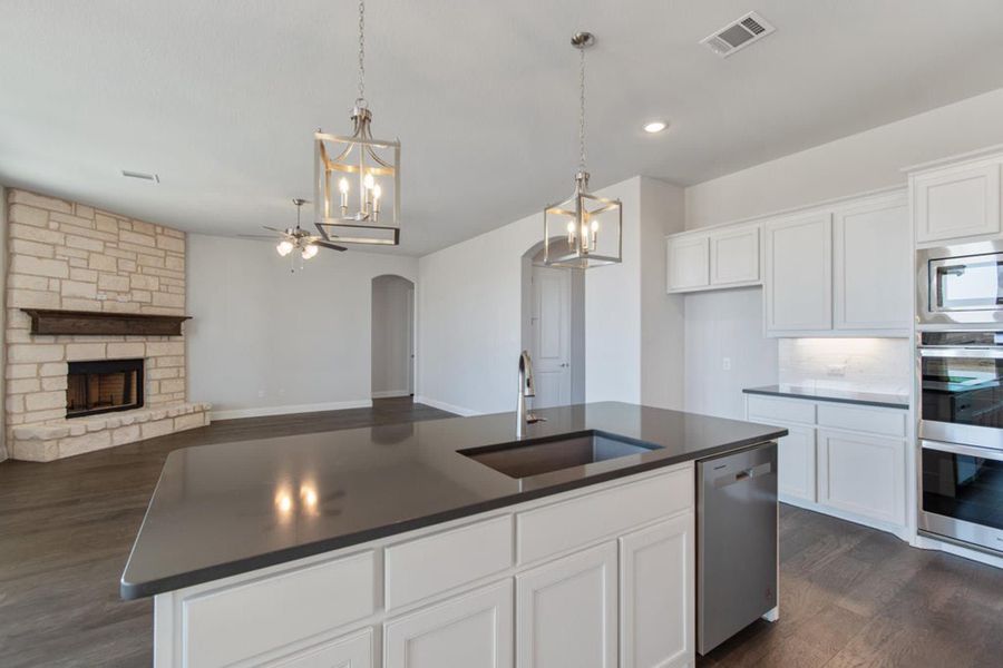 Kitchen to Family Room | Concept 2406 at The Meadows in Gunter, TX by Landsea Homes