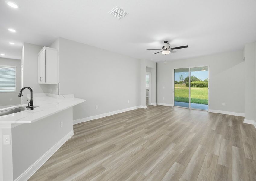 The living room flows seamlessly to the covered patio by gorgeous sliding glass doors The living room flows seamlessly to the covered patio by gorgeous sliding glass doors
