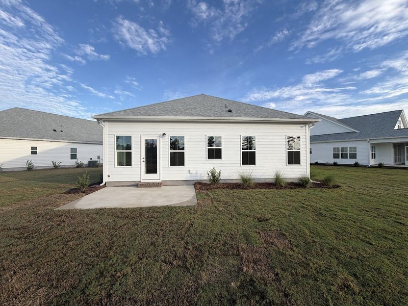 Exterior details and patio area of a home in Songbird, Hampstead (Image 21).