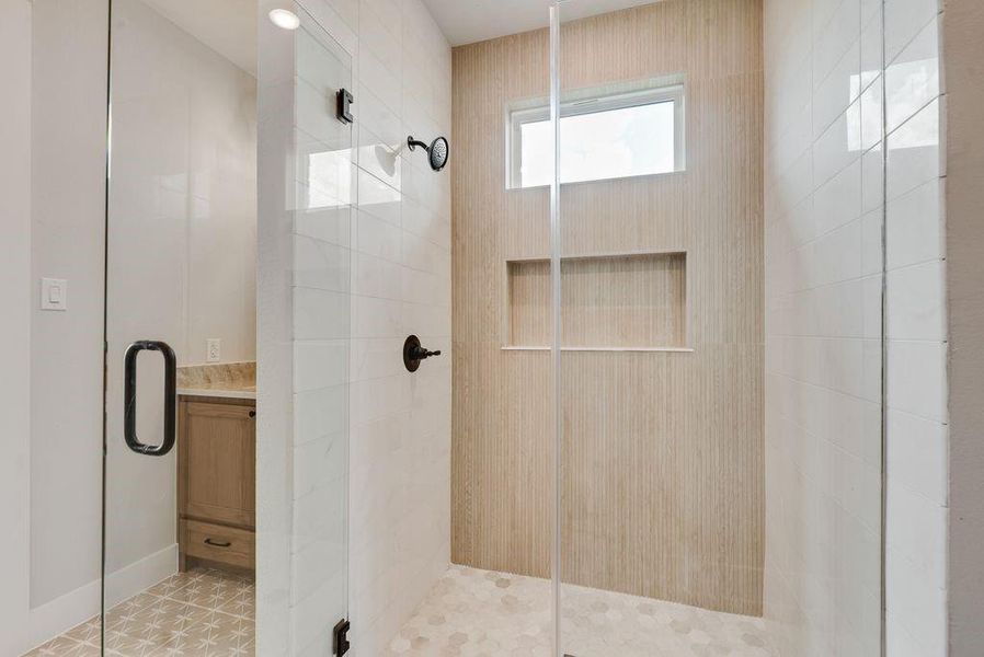Full bathroom featuring a shower stall and vanity