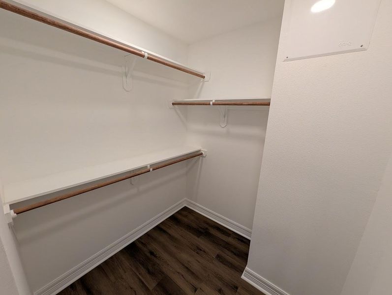The primary suite includes a generous walk-in closet with built-in shelving, providing ample organizational capacity for a professional wardrobe.