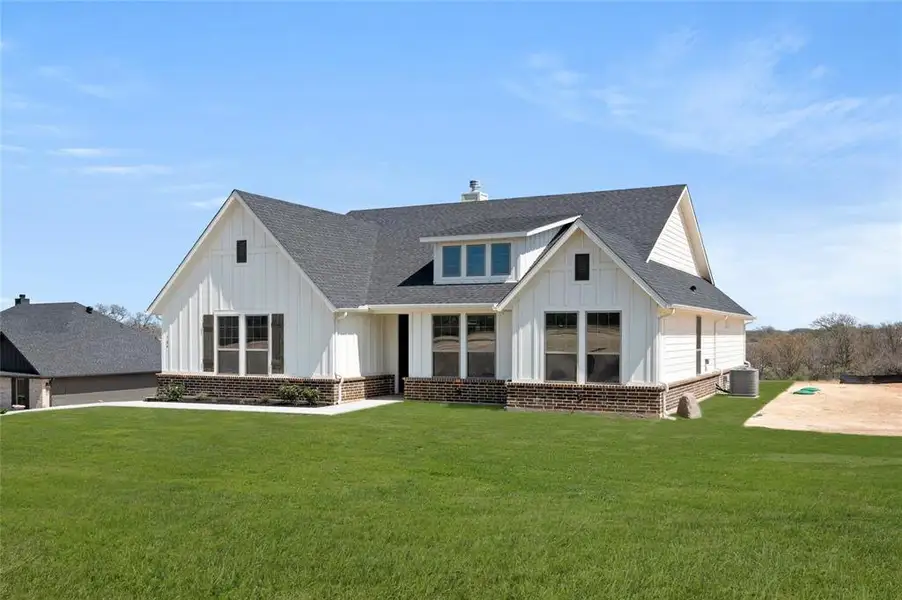 Front exterior of a new home in The Ranches at Valley View, Springtown, TX, highlighting curb appeal (Image 2). Front exterior of a new home in The Ranches at Valley View, Springtown, TX, highlighting curb appeal (Image 2).