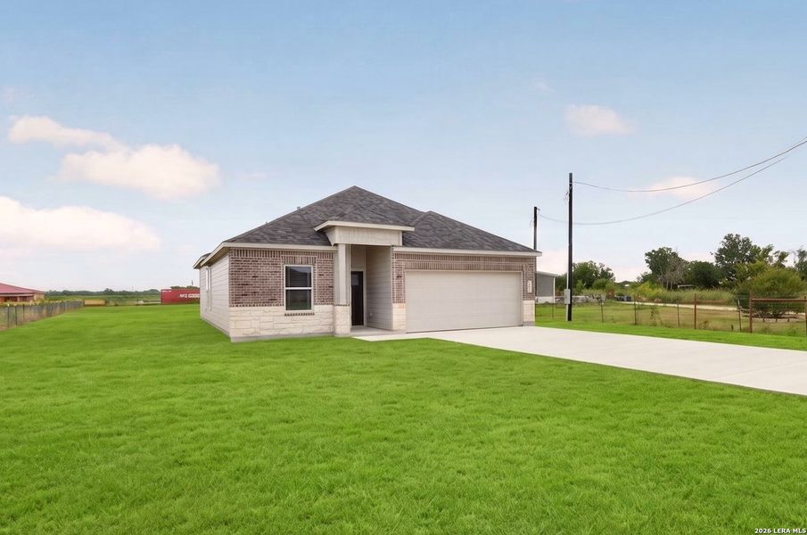 Front exterior of a new home in , Natalia, TX, highlighting curb appeal (Image 2). Front exterior of a new home in , Natalia, TX, highlighting curb appeal (Image 2).