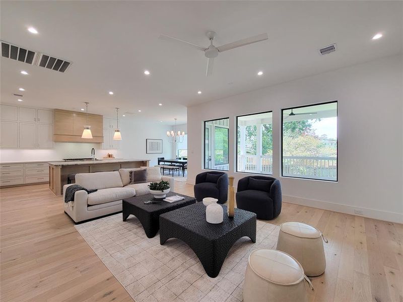 View from the living area toward the kitchen, dining area and private deck with gas connections & ceiling fan.