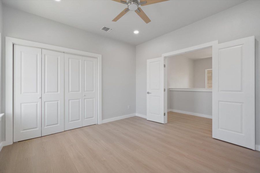 A quiet retreat with light-toned flooring and a convenient wardrobe, offering tranquil living.