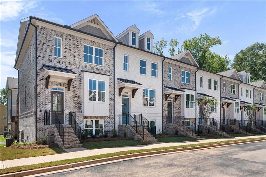 Front exterior of a new home in Evanshire Townhomes, Duluth, GA, highlighting curb appeal (Image 1).