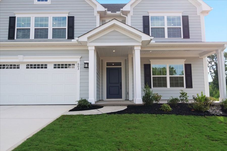 Front exterior of a new home in Canterbrook Farms, Fountain Inn, SC, highlighting curb appeal (Image 2). Front exterior of a new home in Canterbrook Farms, Fountain Inn, SC, highlighting curb appeal (Image 2).
