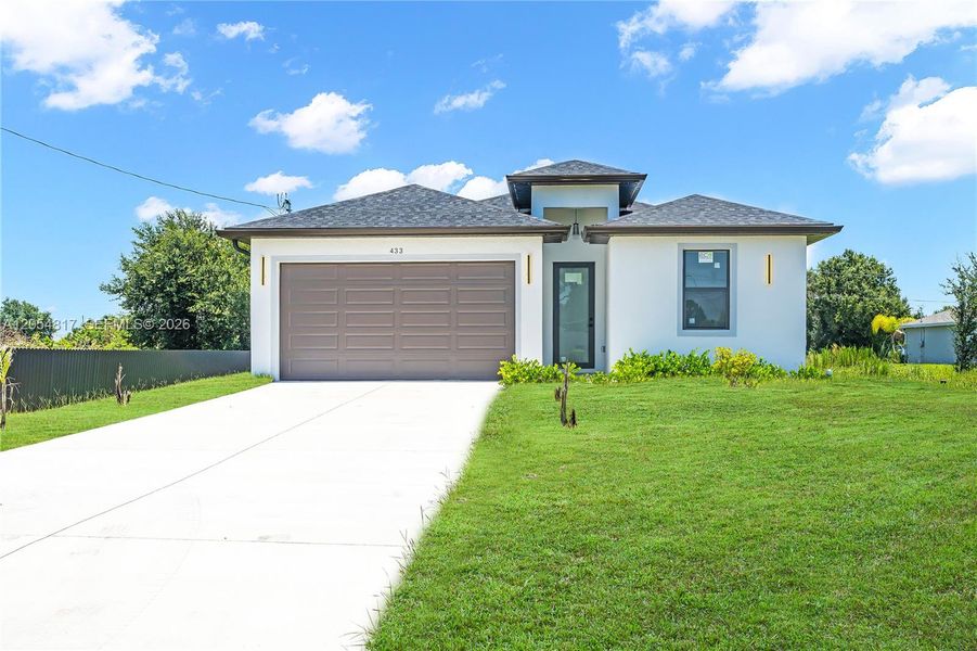 Front exterior of a new home in , Lehigh Acres, FL, highlighting curb appeal (Image 1). Front exterior of a new home in , Lehigh Acres, FL, highlighting curb appeal (Image 1).