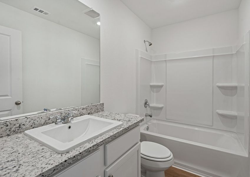 The secondary bathroom features a shower/tub combination