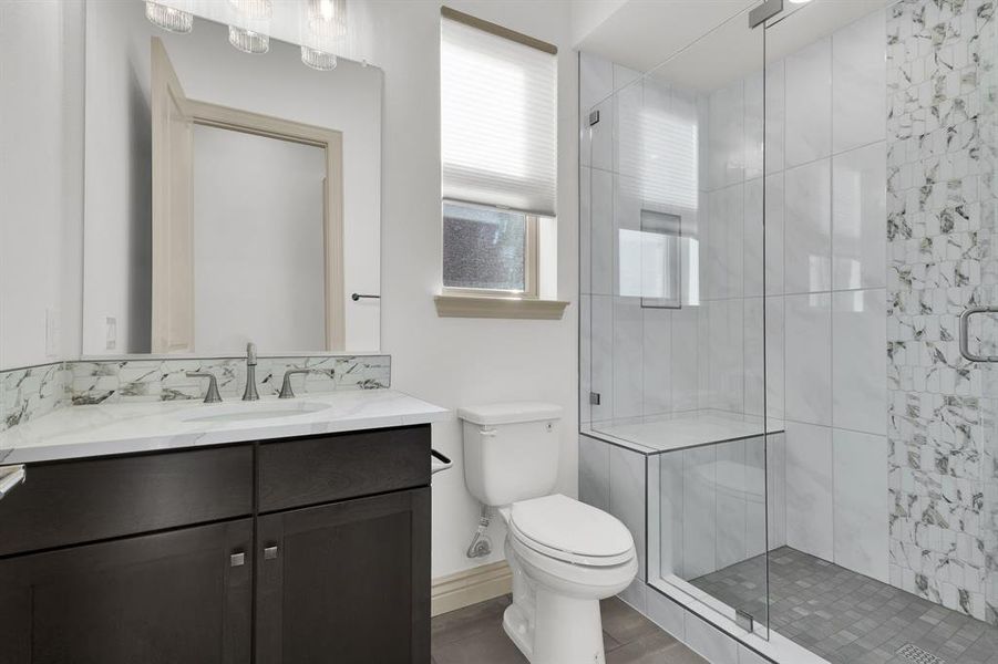 Full bathroom featuring a stall shower and vanity